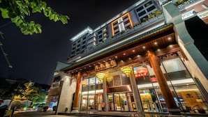 A traditional-style building with a prominent entrance, large windows, and a well-lit facade at night. - Xiang Yun Sha Garden Hotel (Foshan)