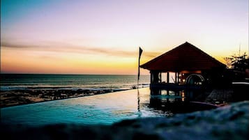 Una piscina al aire libre, sillones reclinables de piscina