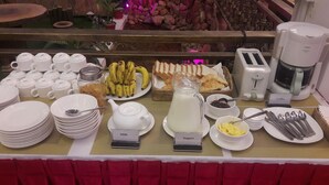 Un bufé de desayuno con diversos alimentos y utensilios.