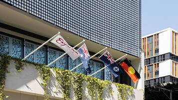 Flags from around the world adorn the balcony of this contemporary building.