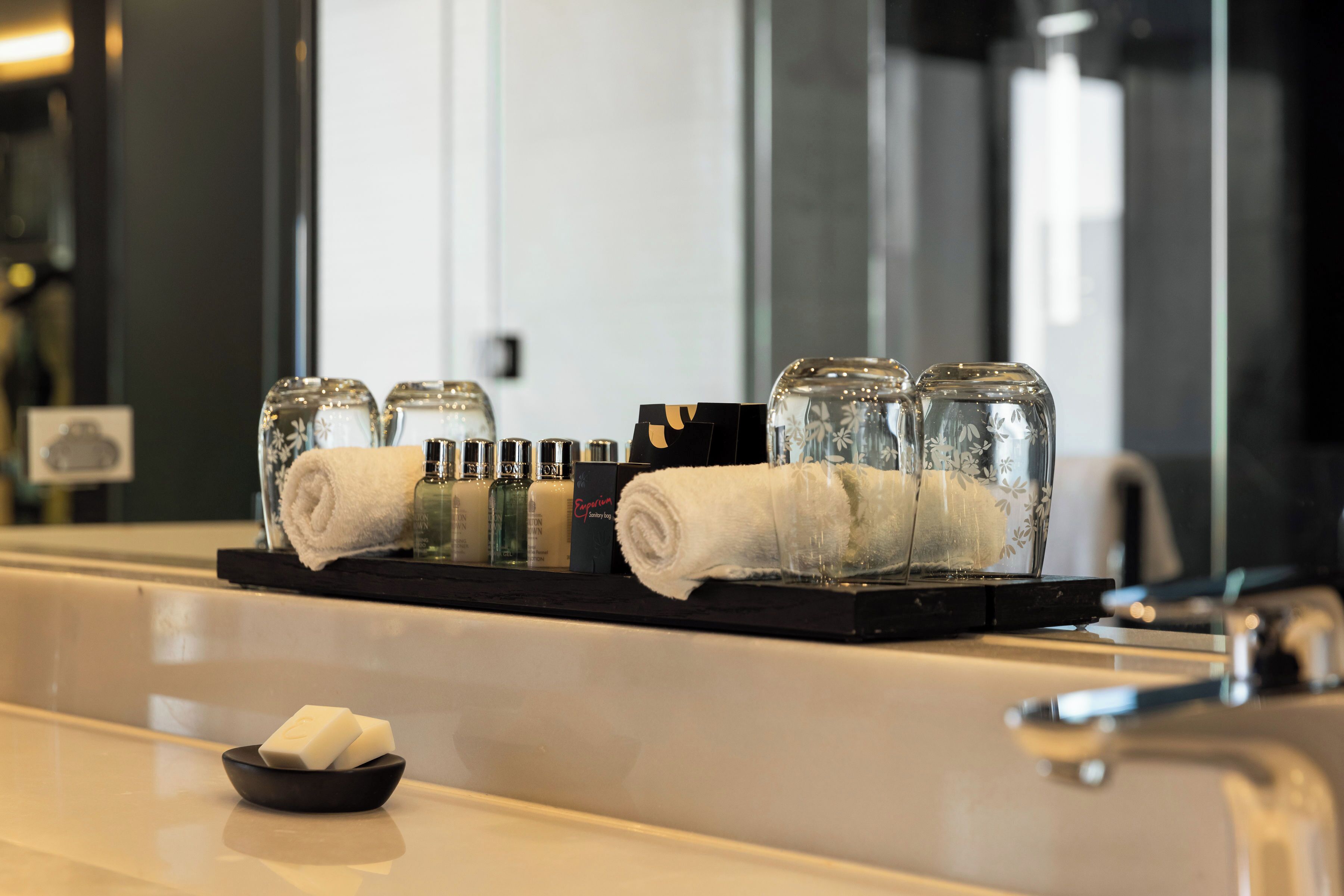 designer toiletries, hair dryer, bathrobes, slippers