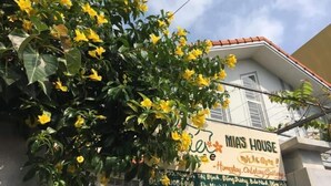Un bâtiment sur lequel est apposée une enseigne indiquant « La maison de Mia », et qui comprend également les coordonnées et les liens vers les réseaux sociaux.