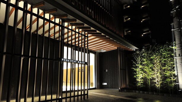 A modern building entrance with a gated entrance, illuminated by vertical lights, and a small tree in the foreground. - FUGASTAY Shijo Omiya (Kyoto)