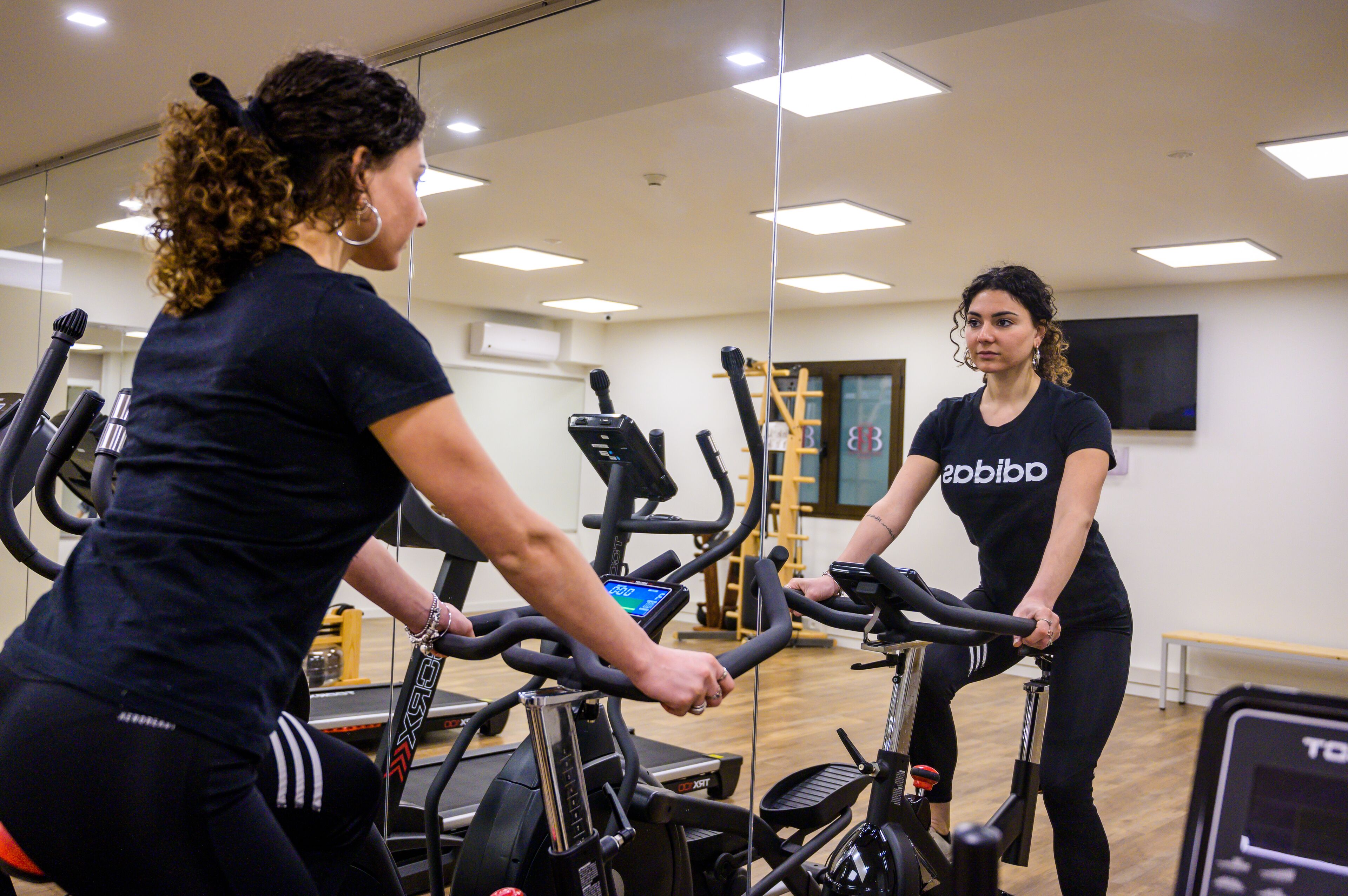 A gym with exercise equipment, including treadmills and stationary bikes.