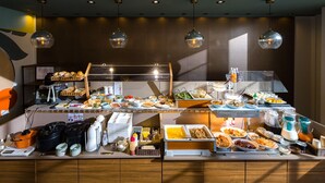 A buffet setup with various food items and condiments, including plates of food, bowls, and containers. - Hotel Oak Shizuoka (Shizuoka)