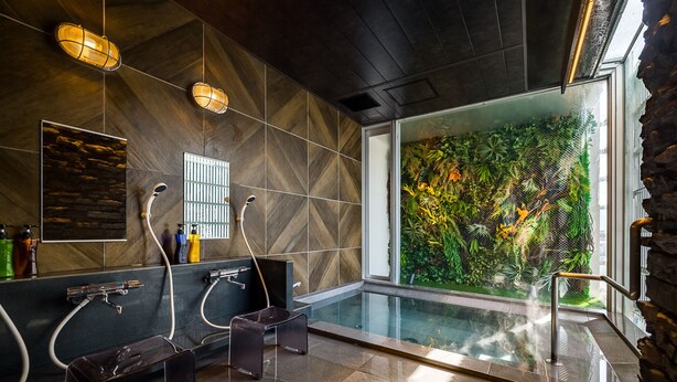 A modern bathroom with a glass-enclosed shower, a black vanity, and a large window with a view of a lush garden. - Hotel Oak Shizuoka (Shizuoka)