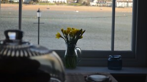 A view from a window overlooking a beach with houses in the background. - Appledore Factory (Bideford)