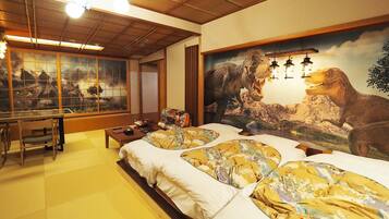 A traditional Japanese room with tatami flooring, a low wooden bed, a desk with chairs, and a large dinosaur mural.