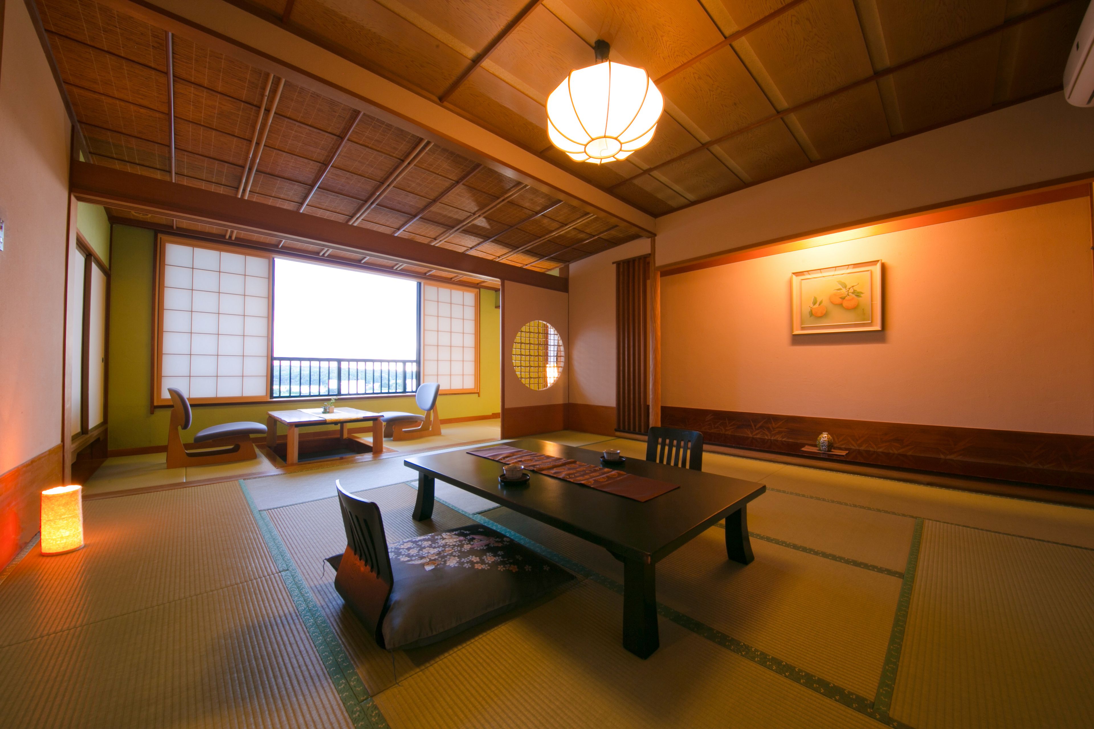 A traditional Japanese room with tatami flooring, a low table, chairs, a sliding door, and a hanging lantern.