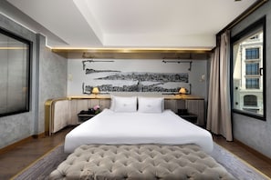 A hotel room with a large bed, a desk, and a cityscape mural on the wall. - The Wings Hotels Karakoy (Istanbul)