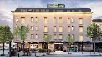 A hotel with a flat facade, multiple windows, and a sign reading 'The Wings Hotel.'