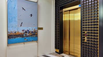 An elevator with a gold interior and a wall-mounted control panel.