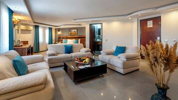 Executive Suite, 1 Bedroom | Living area | LCD TV, foosball, table tennis, books