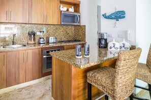 Full-size fridge, microwave, cookware/dishes/utensils
