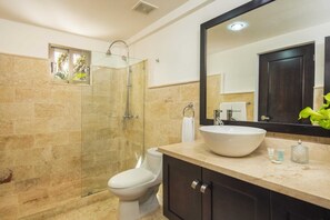 A modern bathroom with a glass-enclosed shower, a white sink, and a large mirror. - Grand Laguna Beach Properties by Calisto Stays (Sosúa)