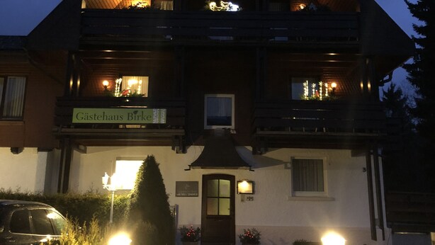 A two-story building with a steeply pitched roof, a visible balcony on the upper floor, and a sign reading "Gästehaus Birk". - Gästehaus Birke (Titisee-Neustadt)