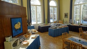 A breakfast buffet setup with various food items and a microwave.