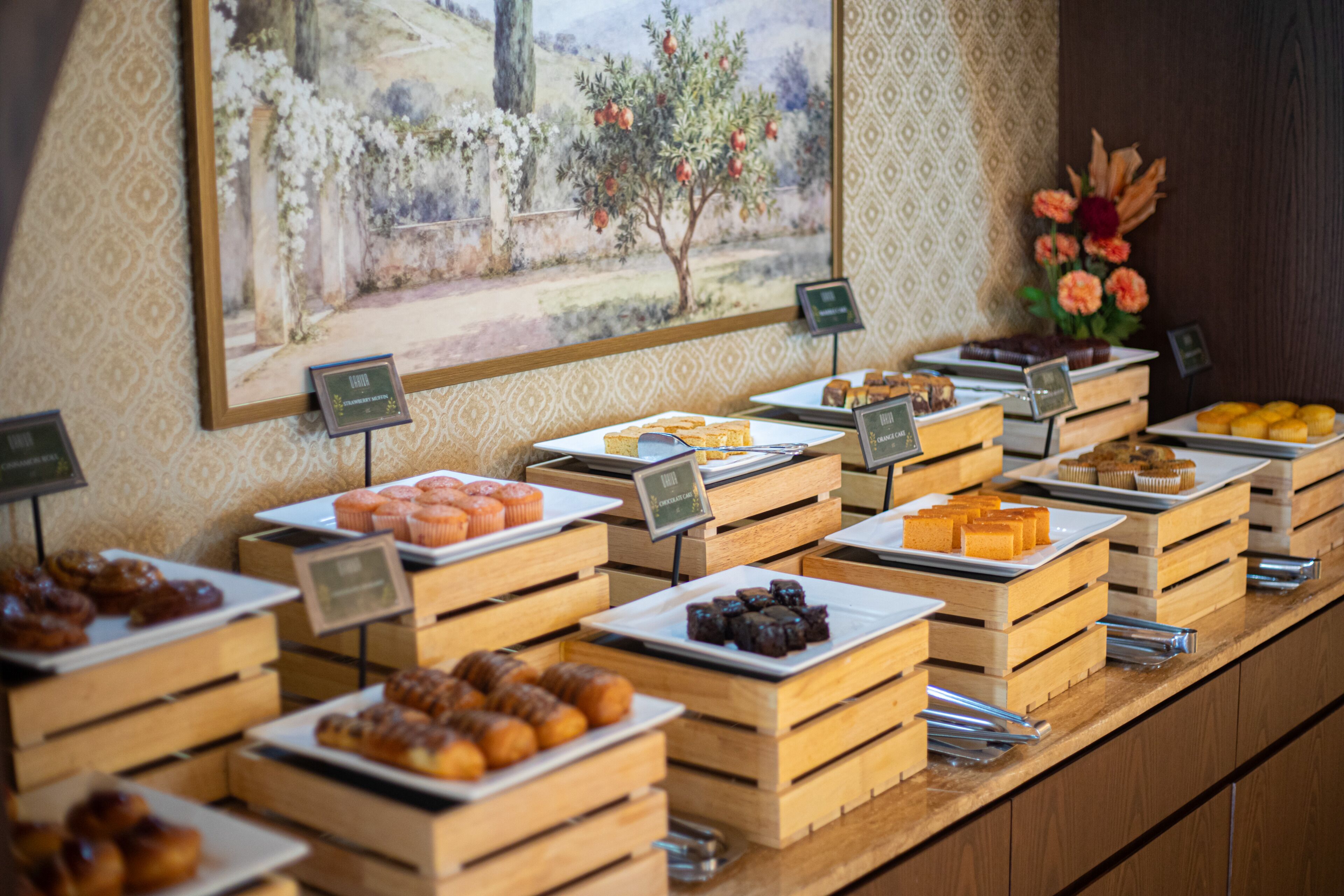 A buffet with various food items displayed in wooden crates.