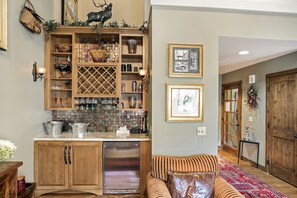A kitchen with wooden cabinets, a built-in wine rack, and a stainless steel dishwasher. - Vail Point (Vail)