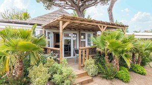 A wooden pergola over a covered patio area with steps leading to a glass door. - La Toison d'Or Resort & Spa (Ramatuelle)