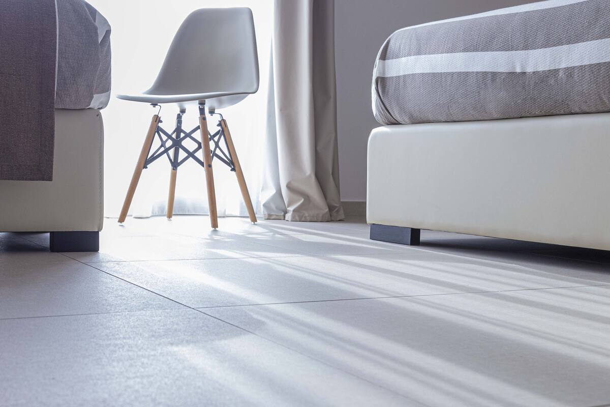 Uma sala de estar moderna com um sofá, uma poltrona e uma pequena mesa.