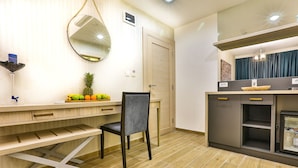 A modern kitchen with a wooden countertop, a chair, a fruit bowl, and a refrigerator. - Hotel Harmony by Aycon (Petrovac)