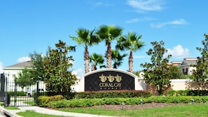 A sign for Coral Cay Resort with palm trees and a clear blue sky. - Coral Cay Resort #2 - 4 Bed 3 Baths Townhome (Kissimmee)