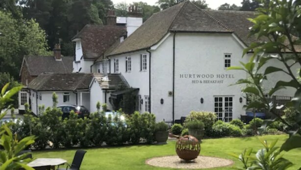 A white building labeled "HURTWOOD HOTEL BED & BREAKFAST" with a garden in front. - Hurtwood Hotel (Guildford)