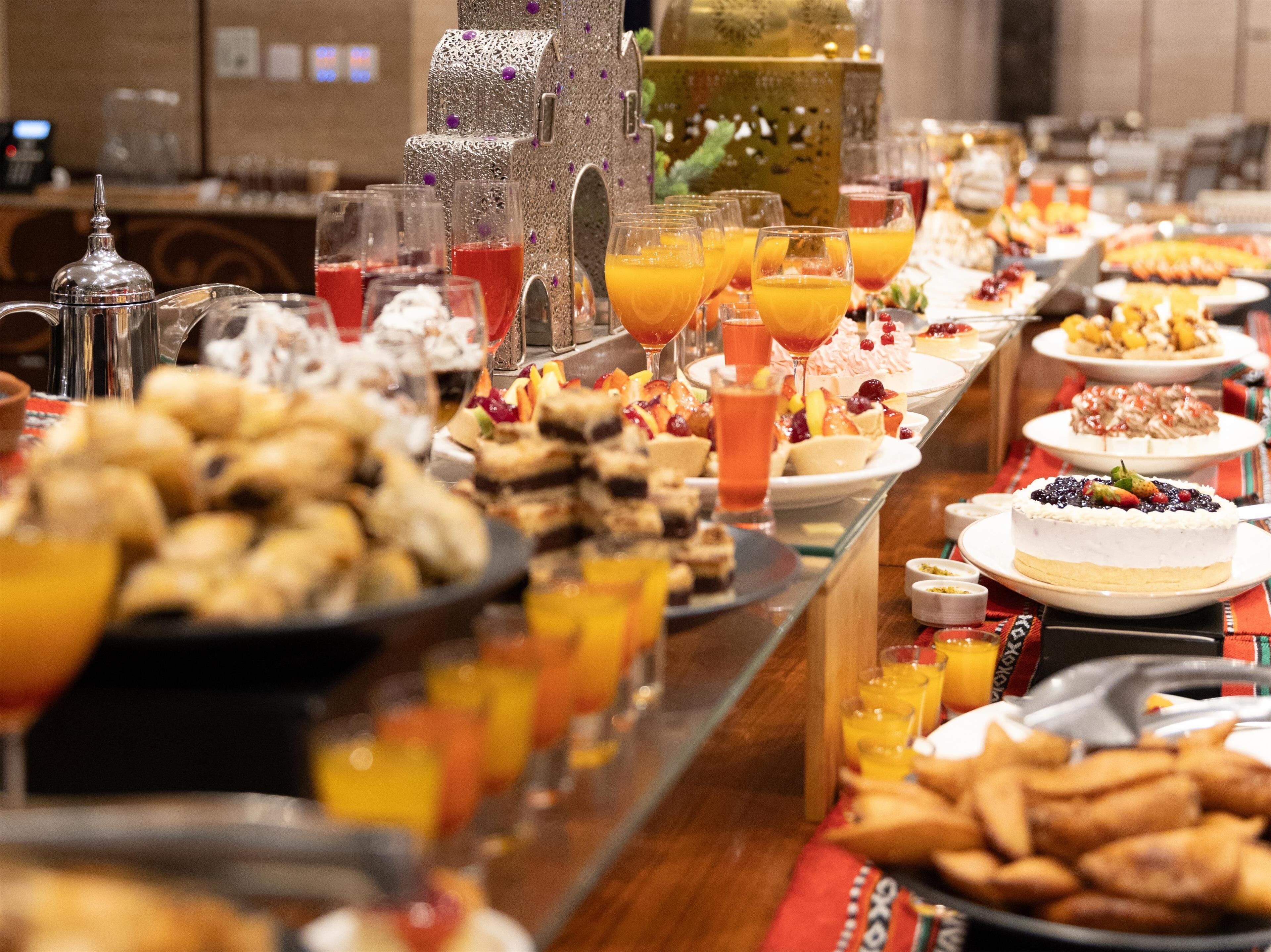 A buffet with various food items and beverages.