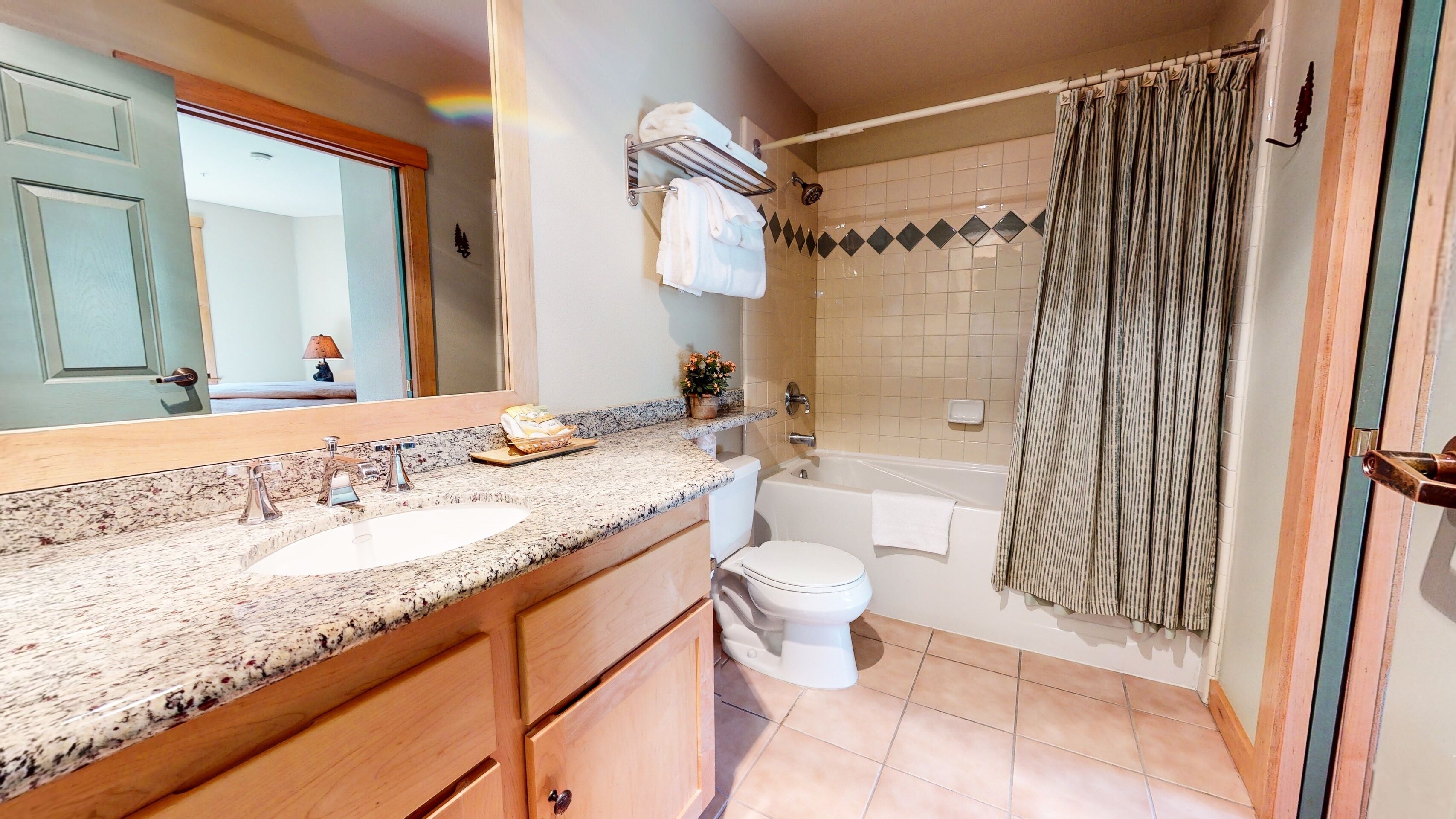 A bathroom with a sink, toilet, and bathtub.