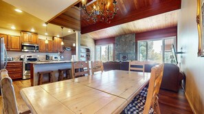 A spacious kitchen with wooden cabinets, a large island, and modern appliances.
