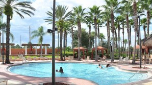 A swimming pool surrounded by palm trees and lounge chairs. - Solana #1 - 7 Bed Villa w/ Private Pool (Davenport)