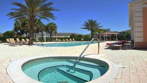 A swimming pool with a hot tub, surrounded by lounge chairs and palm trees. - Shv1173ha - 4 Bedroom Townhome In Coral Cay Resort, Sleeps Up To 10, Just 6 Miles To Disney (Kissimmee)
