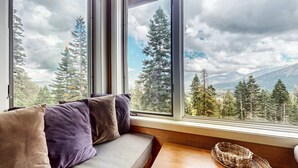 A room with a large window overlooking a forest and mountains. - Bridges Townhome 13 Mountain View Townhome just Steps to the Slopes with Private Garage and Washer Dryer by RedAwning (Mammoth Lakes)