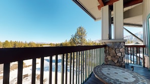 A balcony with a stone wall and a view of a snowy mountain range. - Juniper Springs Lodge 539 Deluxe Condo Great Complex Amenities near Ski-In Ski-Out by RedAwning (Mammoth Lakes)