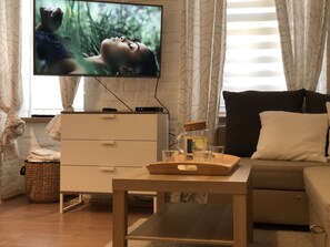 Departamento de diseñador | Área de sala de estar | Juguetes, libros, piso con calefacción y biblioteca musical 