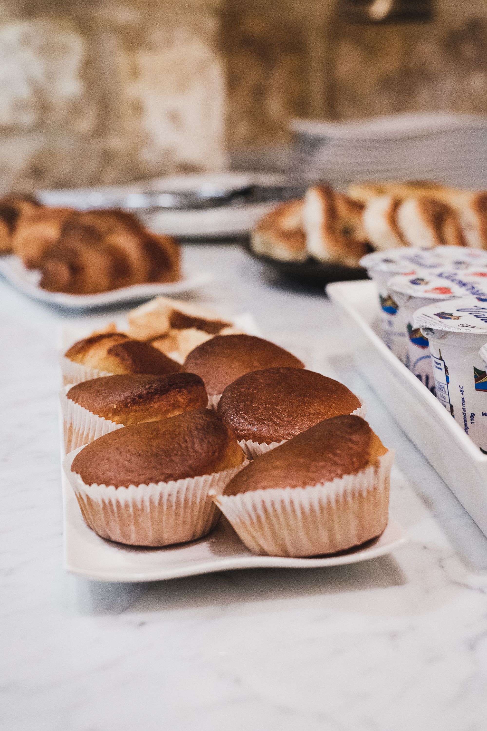 A tray of muffins on a marble surface.
