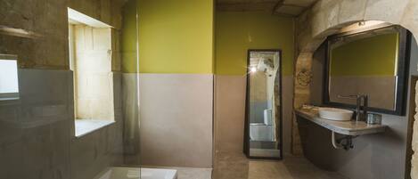 A bathroom with a bathtub, a sink, and a mirror.