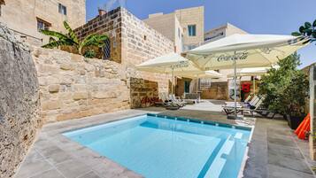 Piscine extérieure, parasols de plage, chaises longues