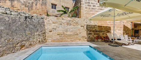 Piscine extérieure, parasols de plage, chaises longues