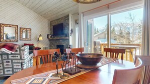 A cozy dining area with a wooden table, chairs, and a large bowl centerpiece.