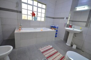 Apartment, 3 Bedrooms | Bathroom | Shower, rainfall showerhead, hair dryer, slippers