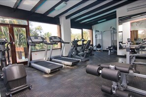 A gym with treadmills, elliptical machines, and weight equipment. - San Lameer Villa Rentals Two Bedroom Standard 1928 (Southbroom)
