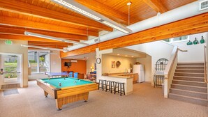 A pool table in a spacious room with wooden beams and a carpeted floor. - Blue Heron Holidays (Union)