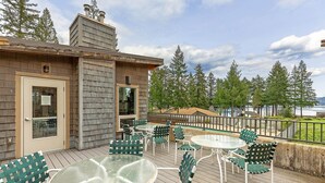 A deck with outdoor seating and a view of the ocean. - Blue Heron Holidays (Union)