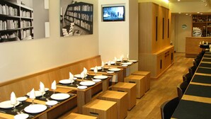 A restaurant with multiple dining tables, each set with plates, glasses, and cutlery. - Hostal Sol Square Madrid (Madrid)