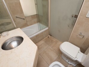 A bathroom with a bathtub, toilet, and sink. - Dto Libertad 1 by For Rent Argentina (Buenos Aires)