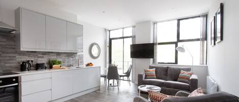 Executive Apartment, 2 Bedrooms, Kitchen, City View | Living area | 50-inch Smart TV with satellite channels, TV