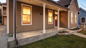 A two-story house with a front porch, a visible number '929', and a well-maintained lawn.