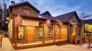 A two-story building with a sign reading "Big Moose Yach Club Private."